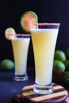 Indian traditional sweet green mango juice. Also known as Aam Panna, Ambyache Panha. Summer Refreshing drink made with raw mangos, jaggery, and salt. Recipe ingredients with copy space.