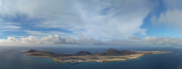 La Graciosa island, in the Canary Islands, in a panoramic photo. Full view of La Graciosa from the viewpoint called the River, located in Lanzarote.