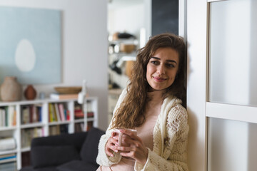 woman relaxing at her home, drinking morning coffee