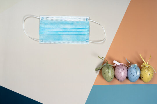 Layout, Easter eggs and a medical mask. Concept Easter lockdown, Coronavirus: new strain, stay at home