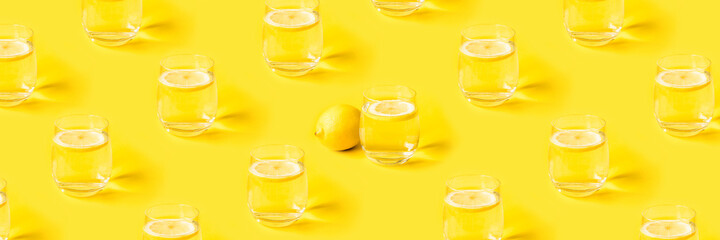 Summer pattern with glasses of lemonade on yellow background.