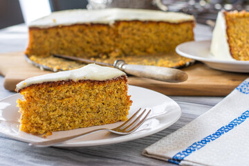 Almond cake with carrots and lemon glaze on a coffee table