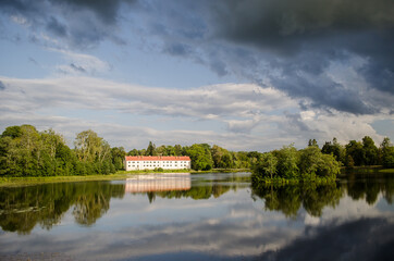 Pond in the summer with dark clouds and reflections, Edole, Latvia