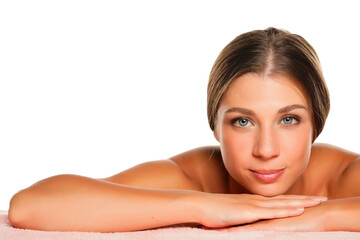 Portrait of a young smiling beautiful woman laying down