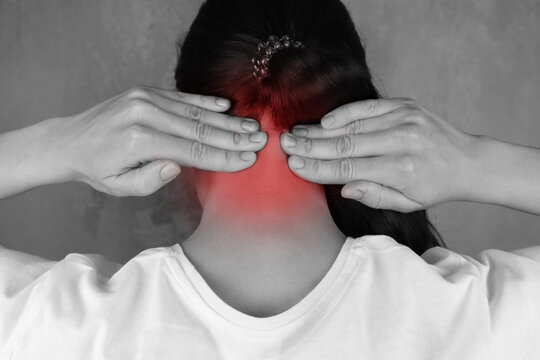 Woman put her hands on neck, red pain area on black and white