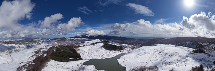 180 degree virtual reality panorama of the Cartolari lakes on the Nebrodi mountains in winter. View of snow-capped Mount Etna, Sicily, Italy. Snow and ice in Sicily. Lake Trearie.