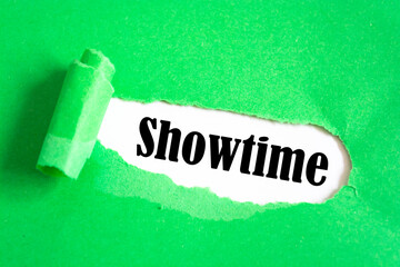 Torn green paper revealing the word Showtime