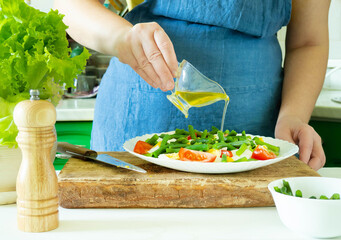 A woman prepares a vegetable salad in the kitchen. Healthy Food. The Concept Of A Diet. Healthy Lifestyle. I Cook At Home. Prepare