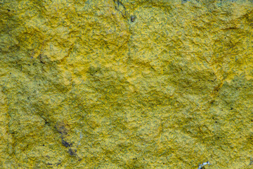 background of granite stone close-up, painted in yellow color, copy space, place for text
