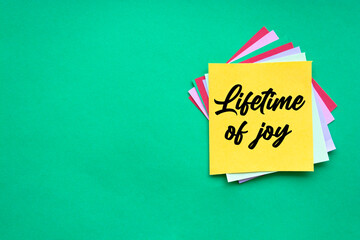 Text lifetime of joy on the short note texture background