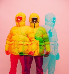 Young man in yellow puffy jacket isolated on pink background with glitch effect.