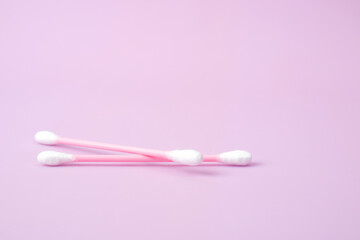 Cotton swabs isolated on pink background. Beauty and hygiene concept.