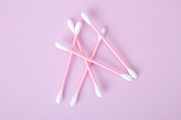 Cotton swabs isolated on pink background. Beauty and hygiene concept.