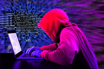 Hacker in a purple hoody in front of a blue code background with binary streams and information...