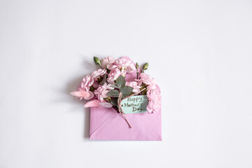 Close up envelope with flowers wishing happy mothers day isolated.
