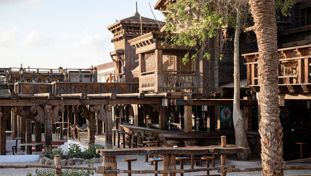 Wooden house with many wooden details in a tropical setting.