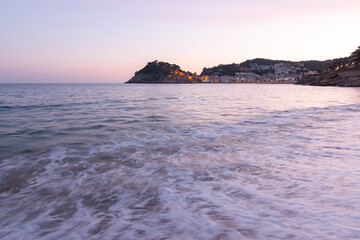 Stone wall and towers of the castle at the Mediterranean sea beach in Tossa de Mar village, Costa Brava, Spain, Europe