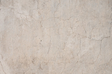 Texture of an old cemented cracked wall. Obsolete putty exterior of the building