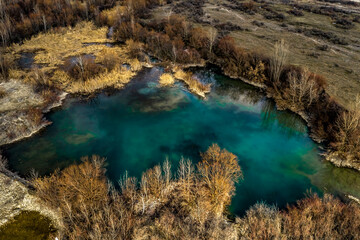Turquoise lake among the trees. North Caucasus, Russia. 
