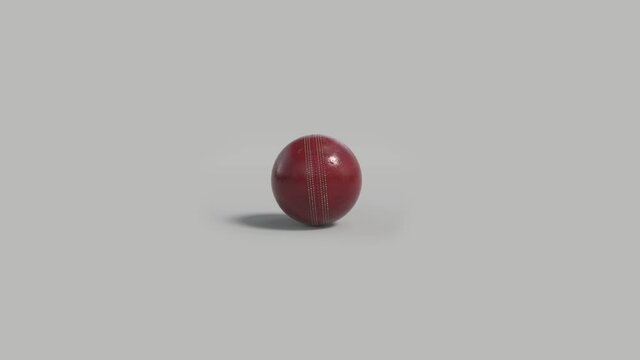 Side on view of a 3D cricket ball slowly rolling from left to right. Shiny red cricket ball in a continuous roll perfect for sports advertising. 4K clip at 30fps for smooth motion with an alpha matte 