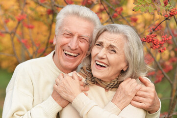 portrait of beautiful senior couple in autumn park