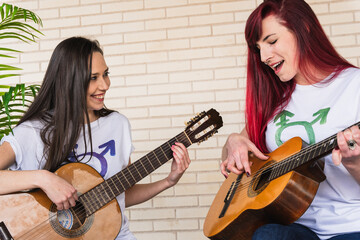 Female guitarists looking at each other