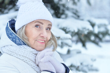 Happy beautiful senior woman in warm hat