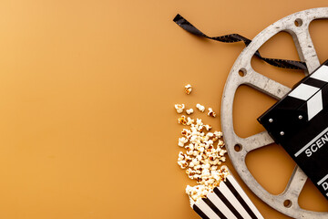 Movie film reel with clapperboard and popcorn. Cinema concept