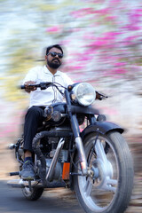 Fototapeta na wymiar man on a motorbike on the road riding. having fun driving the empty road on a motorcycle tour journey. copy space for your individual text 