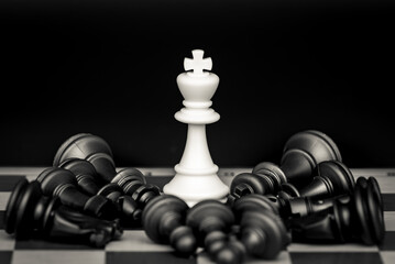 Concept of victory and defeated enemies. Made with chess figures on a chessboard.