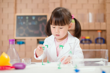 young girl plays  science experiment for home schooling