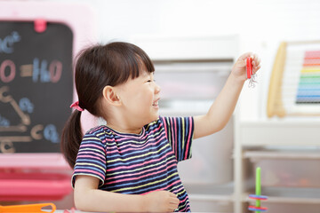 young  girl  play magical magnet experiments at home for homeschooling