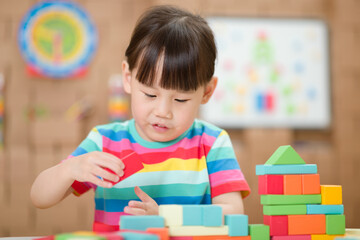  young girl playing creative toy blocks for homeschooling