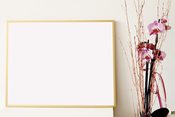 Obraz premium empty landscape frame for pictures, arts and photography on white table with pink orchid flower