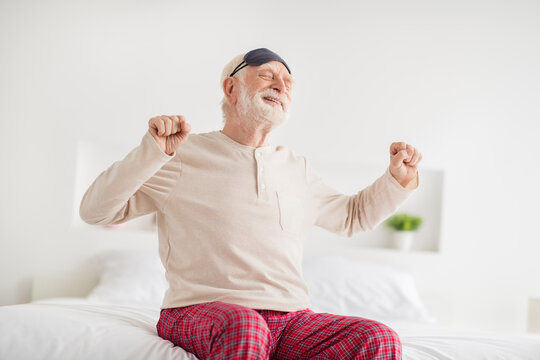 Photo Of Aged Sleepy Man Happy Positive Smile Sit On Bed Home Stretching Wake Up Wear Pajamas Eye Mask