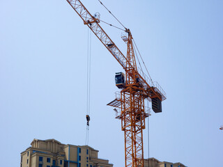 The tower crane on the construction site is busy working