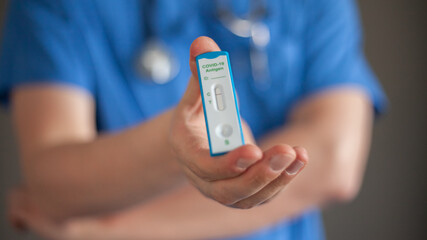 The doctor holds a negative antigen test Covid-19 in his hand 