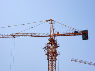 The tower crane on the construction site is busy working