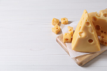 Tasty fresh cheese on white wooden table, closeup. Space for text