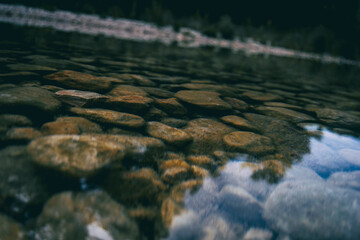 calm stream with many stones on the path
