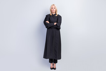 Full length photo of confident blonde old woman hold hands crossed prosecution court isolated on...