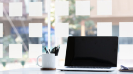 Laptop computer with white blank screen on desk in workspace and copy space concept