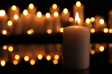 Burning candle in darkness, space for text. Memory day