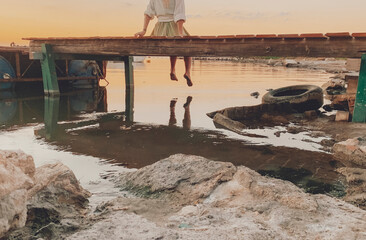 woman staring at a sunset by the lake