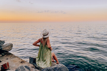woman staring at a sunset by the lake