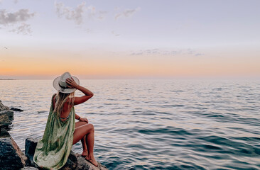 woman staring at a sunset by the lake