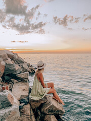woman staring at a sunset by the lake