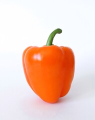Bell pepper (bulgarian pepper) isolated on white. Sweet orange bell pepper on white background, side view