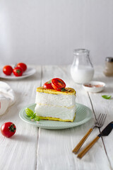 Poulard omelet on a light background with tomatoes
