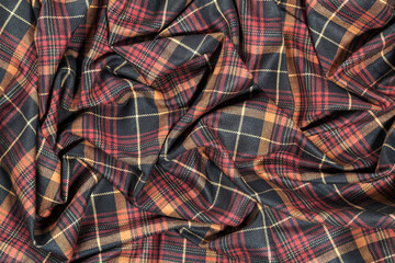 Background with crumpled fabric in checkered. Crumpled checkered fabric.